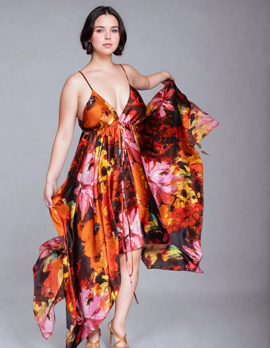 Gaia Butterfly Silk Dress in Sunset Bloom print featuring painterly coral, orange, pink, brown, and golden florals, adjustable straps, and flowing handkerchief hem
