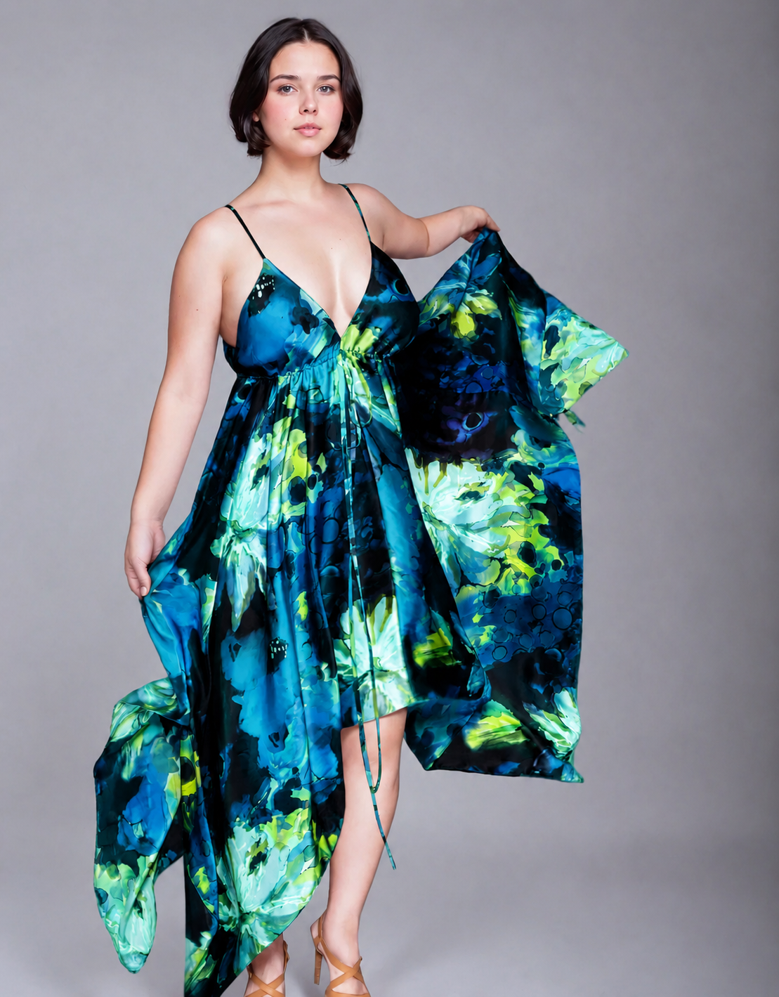 Gaia Butterfly Silk Dress in Tropical Lagoon print featuring painterly blue and aqua florals with deep navy accents, with adjustable straps, and flowing handkerchief hem